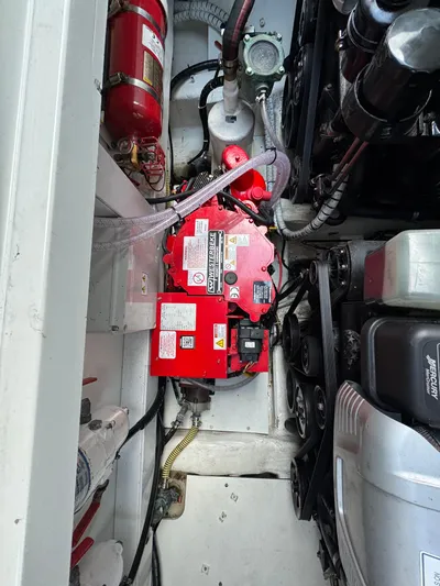  Yacht Photos Pics Engine compartment of 2021 Fairline F//Line 33 with red battery and fire extinguisher.