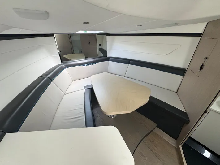  Yacht Photos Pics Interior of 2021 Fairline F//Line 33 yacht with modern seating and table.