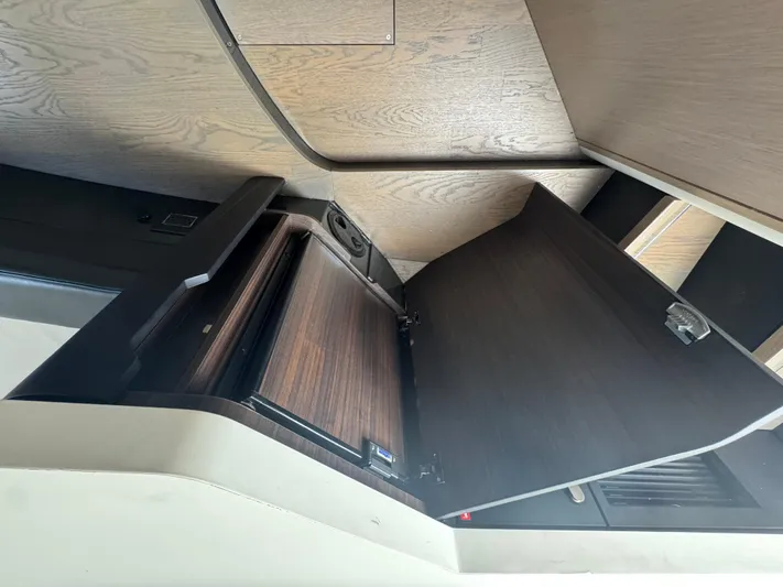 Yacht Photos Pics Interior view of 2021 Fairline F//Line 33 yacht with open wooden cabinet.