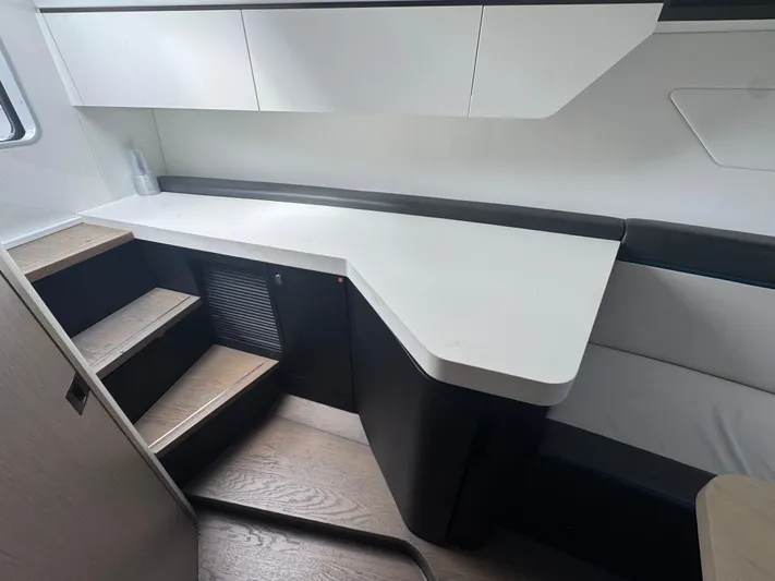  Yacht Photos Pics Interior of 2021 Fairline F//Line 33 yacht with modern cabinetry and stairs.