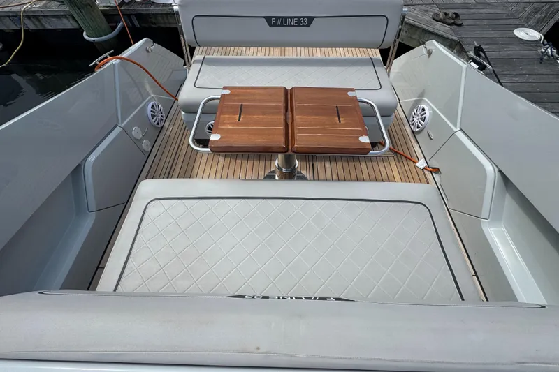  Yacht Photos Pics 2021 Fairline F//Line 33 boat interior with wooden table and cushioned seating.