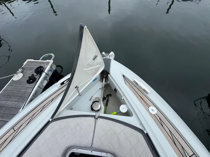 Yacht Photos Pics 2021 Fairline F//Line 33 yacht bow with open anchor hatch at dock.