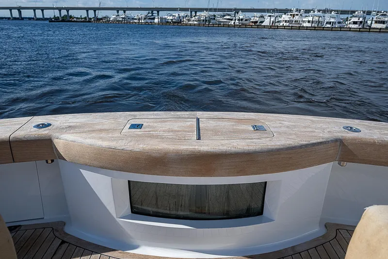 Boobah Yacht Photos Pics 2017 F&S Custom Express Sportfish boat with wooden deck, overlooking marina and bridge.