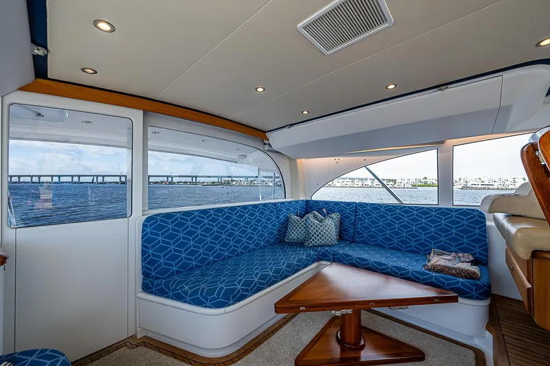 Boobah Yacht Photos Pics Luxurious 2017 F&S Custom Express Sportfish yacht interior with blue seating and wooden table.