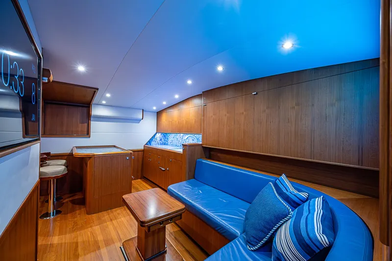 Boobah Yacht Photos Pics Luxurious interior of 2017 F&S Custom Express Sportfish with blue seating and wood finish.