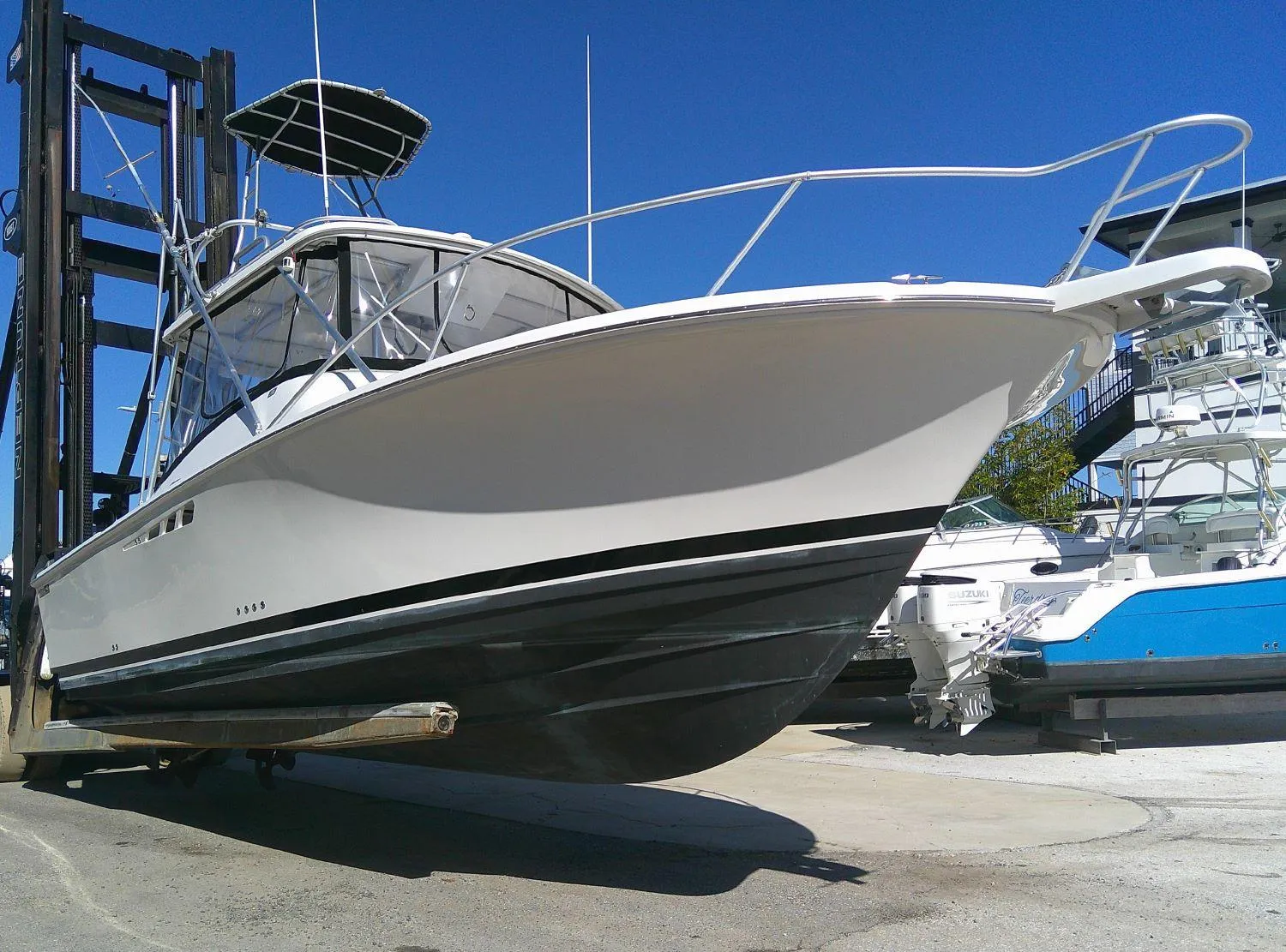 2000 Luhrs Tournament 290 Open boat on lift, showcasing sleek design and sturdy build.