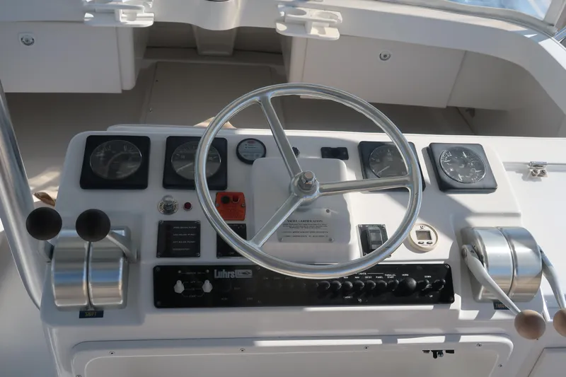 Doran Yacht Photos Pics 2002 Luhrs 40 Convertible helm with steering wheel and control panel.