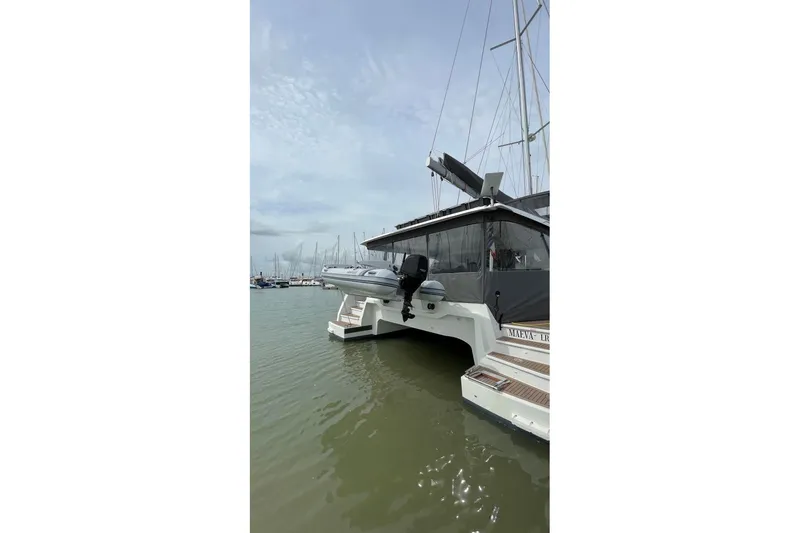 Maeva Yacht Photos Pics 2023 Fountaine Pajot Catamaran Aura 51 docked in a marina, rear view.