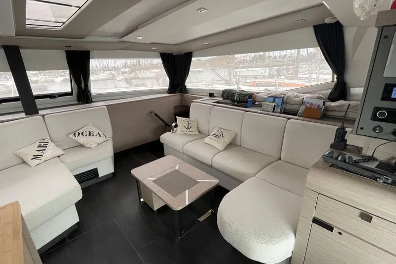 Maeva Yacht Photos Pics Luxurious interior of 2023 Fountaine Pajot Catamaran Aura 51 with elegant seating and decor.