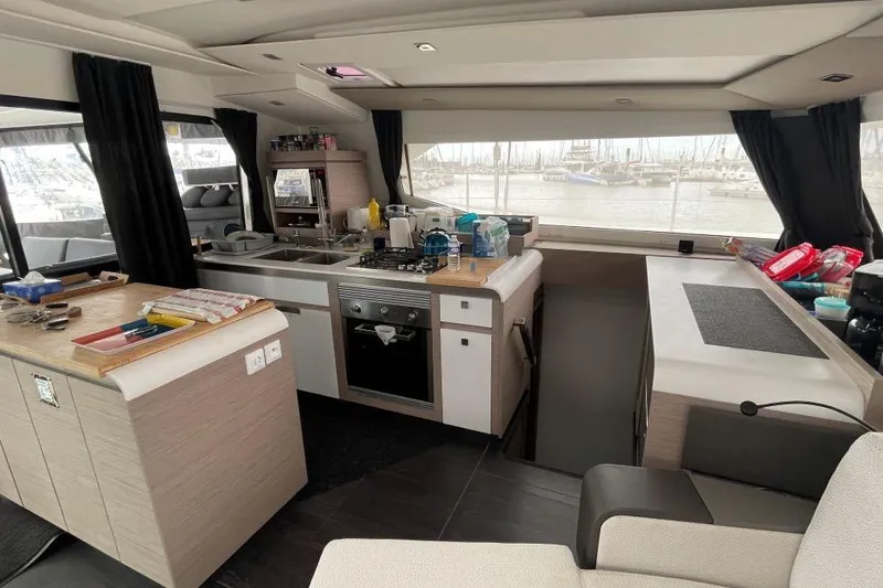 Maeva Yacht Photos Pics Modern kitchen interior of 2023 Fountaine Pajot Catamaran Aura 51 with sleek design and appliances.