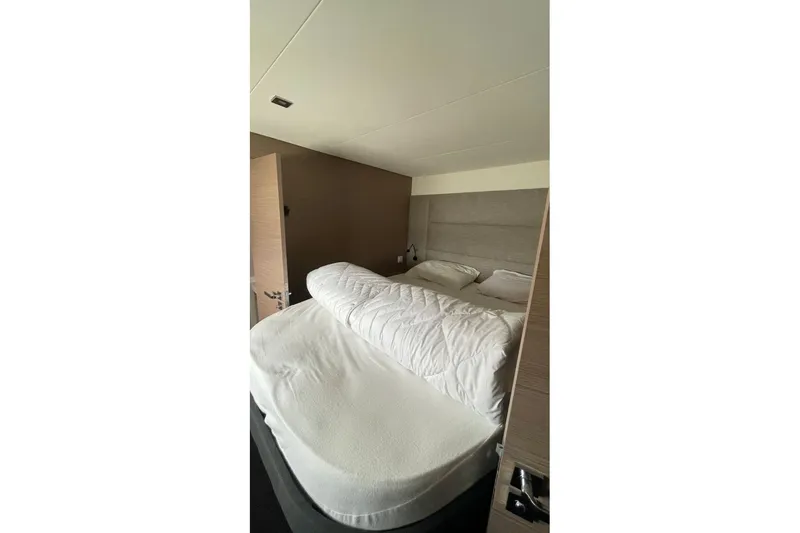 Maeva Yacht Photos Pics Luxurious bedroom interior of 2023 Fountaine Pajot Catamaran Aura 51 with cozy bedding.