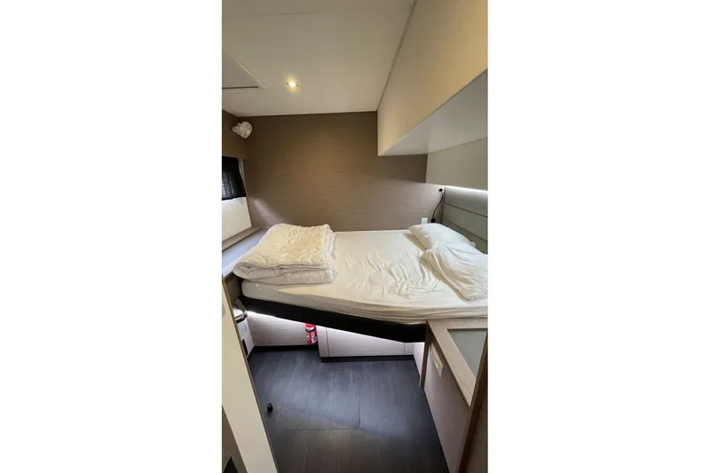 Maeva Yacht Photos Pics 2023 Fountaine Pajot Catamaran Aura 51 cabin with modern interior and cozy bedding.