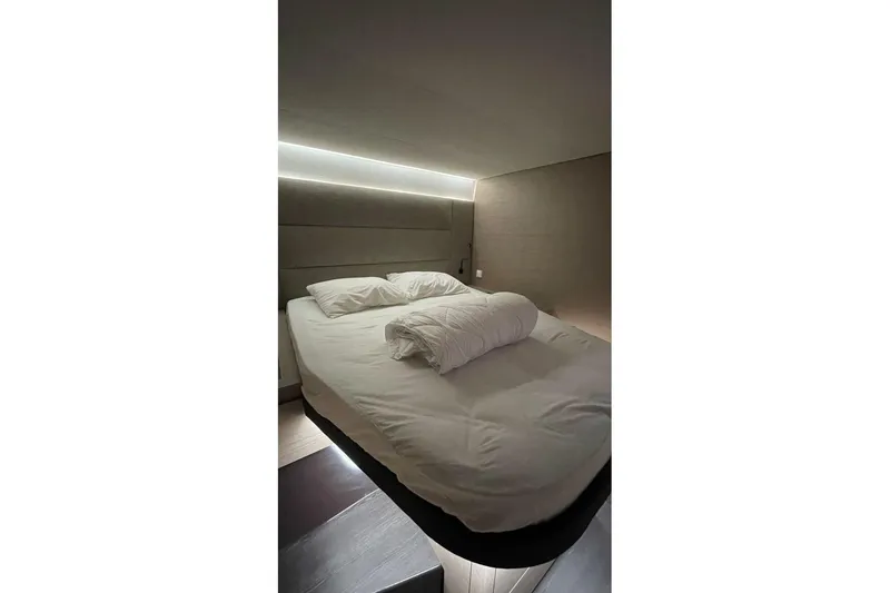 Maeva Yacht Photos Pics Luxurious bedroom interior of 2023 Fountaine Pajot Catamaran Aura 51 with modern lighting.