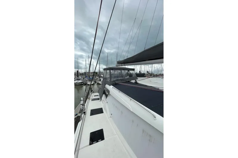 Maeva Yacht Photos Pics 2023 Fountaine Pajot Catamaran Aura 51 docked in a marina under cloudy skies.