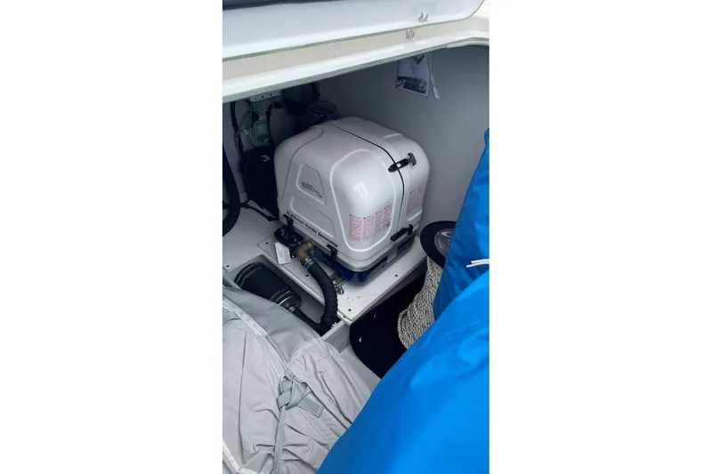 Maeva Yacht Photos Pics Engine compartment of 2023 Fountaine Pajot Catamaran Aura 51, featuring a compact generator.
