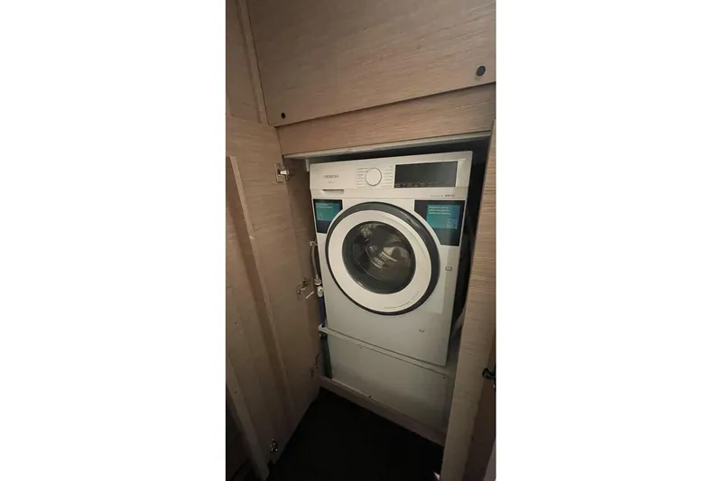 Maeva Yacht Photos Pics Washing machine inside 2023 Fountaine Pajot Catamaran Aura 51, compact and efficient design.