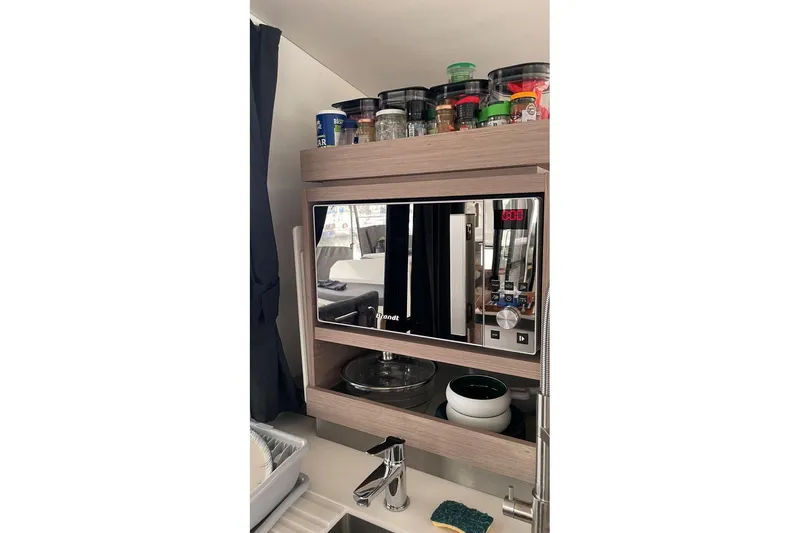 Maeva Yacht Photos Pics Modern kitchen area in 2023 Fountaine Pajot Catamaran Aura 51 with microwave and spice rack.