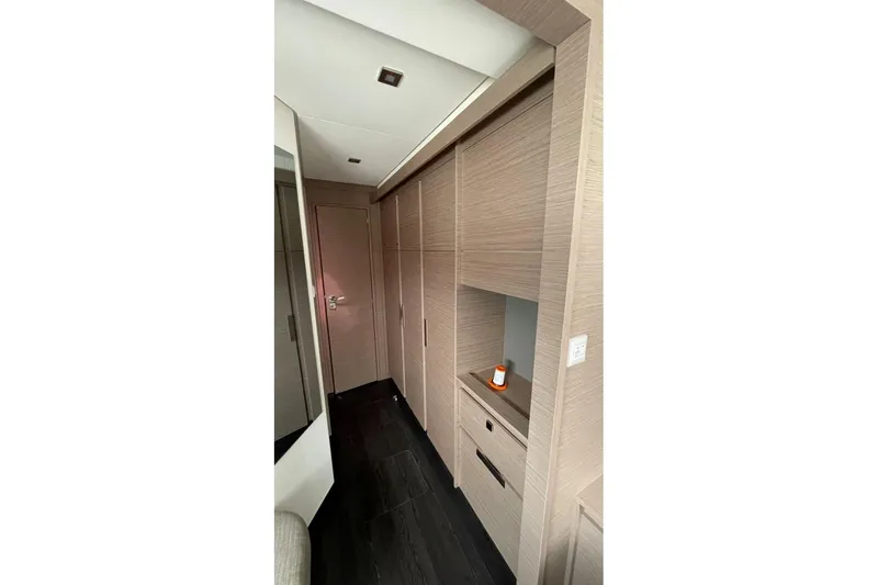 Maeva Yacht Photos Pics Interior hallway of 2023 Fountaine Pajot Catamaran Aura 51 with modern wood finish.