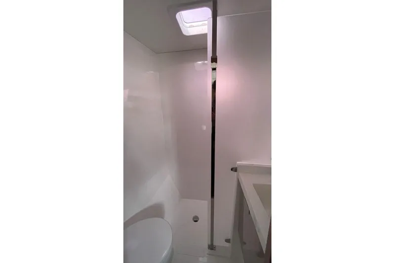 Maeva Yacht Photos Pics Modern bathroom interior of 2023 Fountaine Pajot Catamaran Aura 51, featuring sleek design.