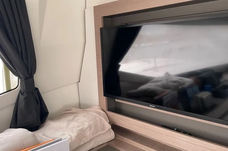 Maeva Yacht Photos Pics Interior of 2023 Fountaine Pajot Catamaran Aura 51 with TV and cozy seating area.