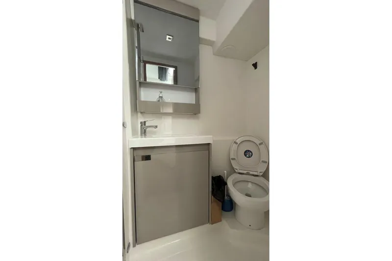 Maeva Yacht Photos Pics Modern bathroom in 2023 Fountaine Pajot Catamaran Aura 51, featuring sleek fixtures and compact design.