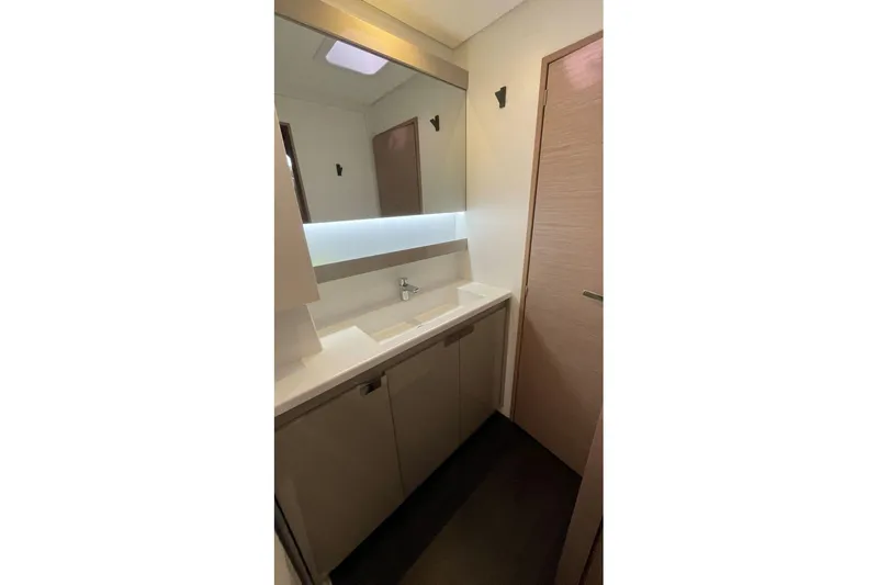 Maeva Yacht Photos Pics Modern bathroom interior of 2023 Fountaine Pajot Catamaran Aura 51, featuring sleek design.