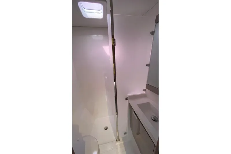 Maeva Yacht Photos Pics 2023 Fountaine Pajot Aura 51 catamaran bathroom with modern fixtures and skylight.
