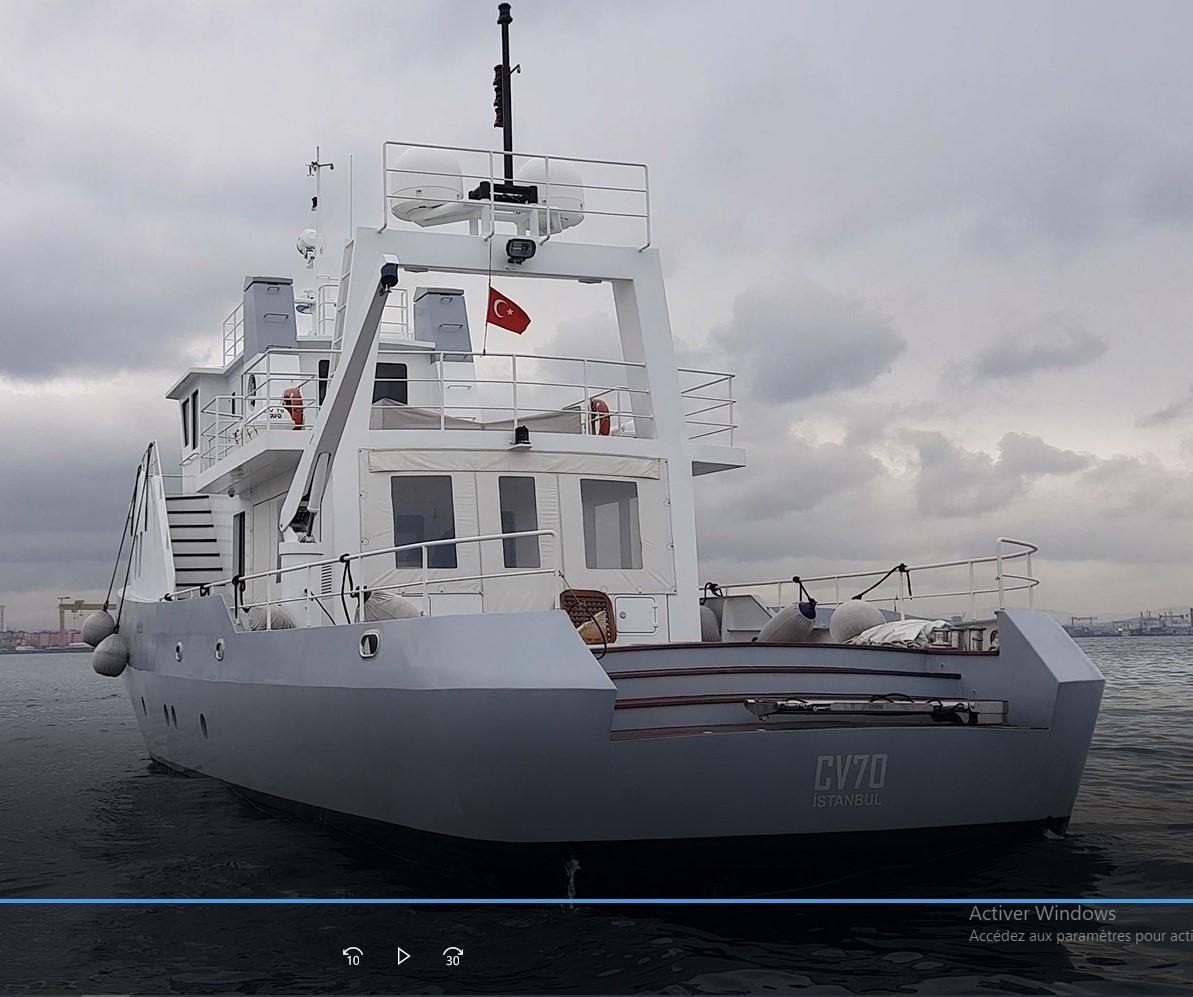 Explorer 70' 2005 yacht on cloudy sea, featuring a white hull and deck.
