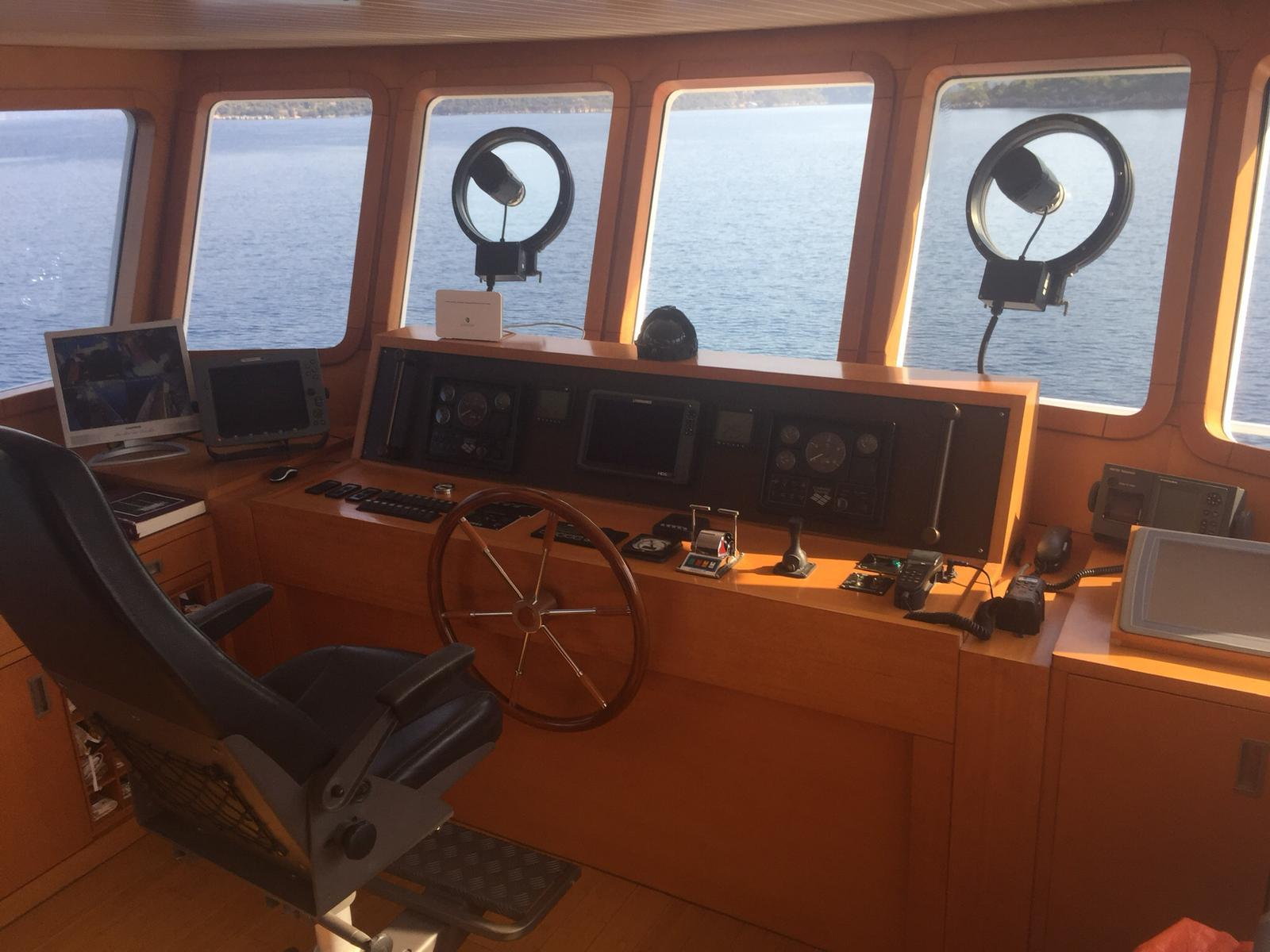 Pilothouse of 2005 Explorer 70' yacht with navigation equipment and ocean view.