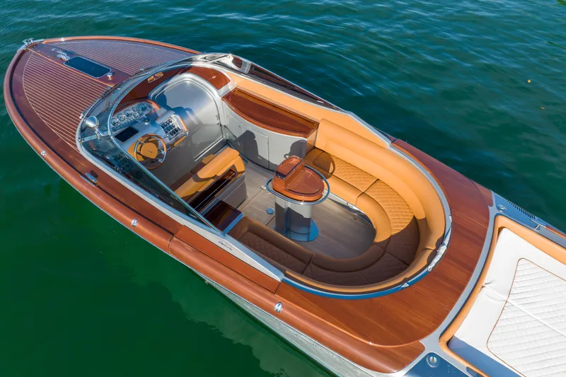 Mia Mia Yacht Photos Pics 2020 Riva Aquariva luxury boat with elegant wooden deck and plush seating on water.