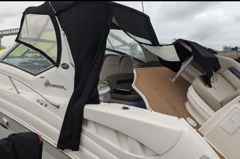  Yacht Photos Pics 2004 Sea Ray 340 Sundancer boat with black canopy and spacious deck.