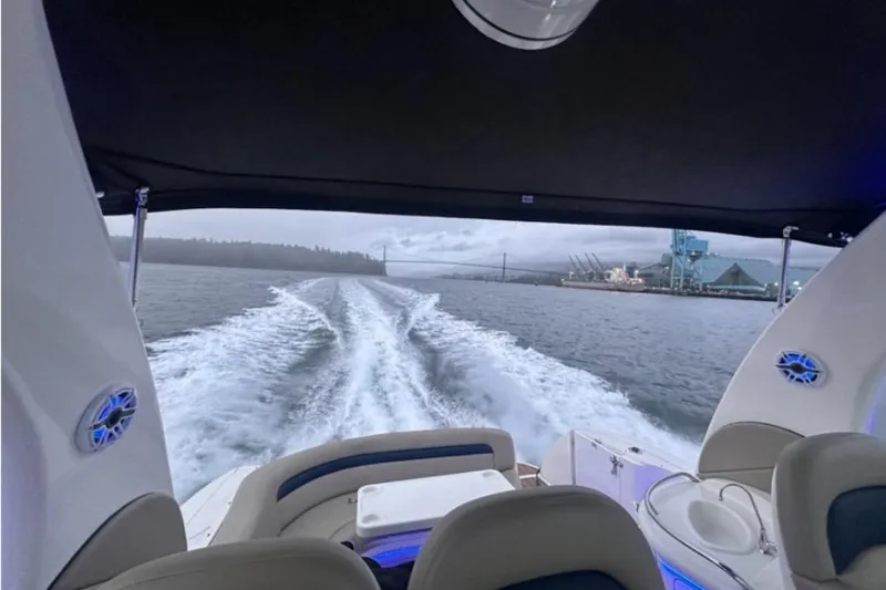  Yacht Photos Pics 2004 Sea Ray 340 Sundancer cruising on open water, leaving a wake behind.