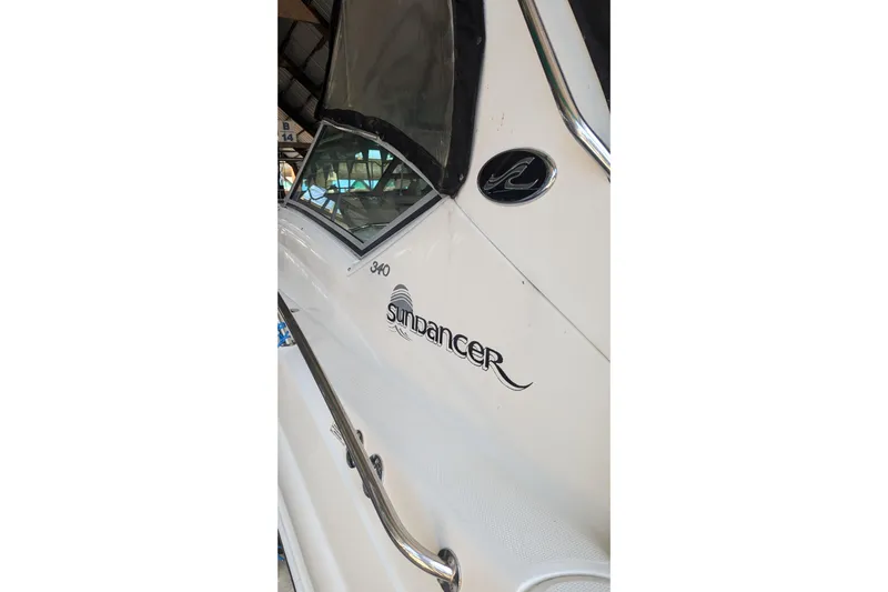  Yacht Photos Pics 2004 Sea Ray 340 Sundancer boat side view with logo and window detail.