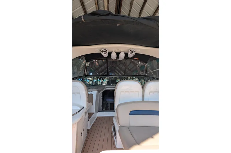  Yacht Photos Pics 2004 Sea Ray 340 Sundancer boat interior with seating and helm under canopy.