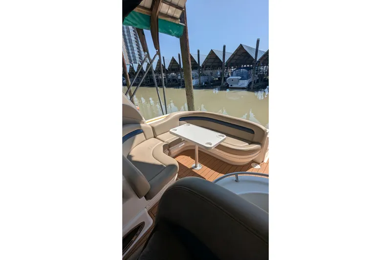  Yacht Photos Pics 2004 Sea Ray 340 Sundancer boat interior with seating and table, docked at marina.