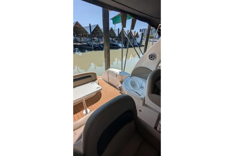  Yacht Photos Pics 2004 Sea Ray 340 Sundancer interior with seating and sink, docked at marina.