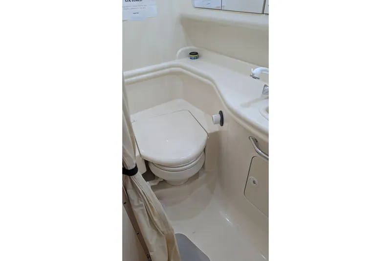  Yacht Photos Pics Bathroom interior of 2004 Sea Ray 340 Sundancer yacht, featuring compact toilet and sink.