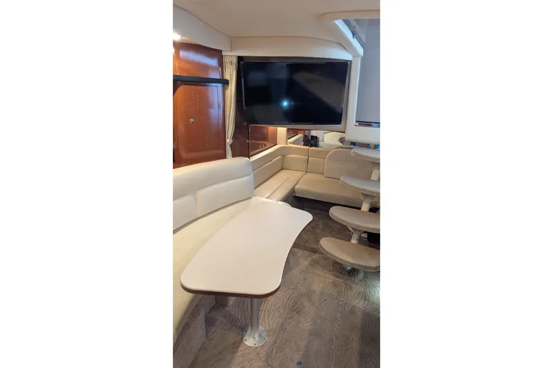  Yacht Photos Pics Interior of 2004 Sea Ray 340 Sundancer with beige seating and wooden accents.