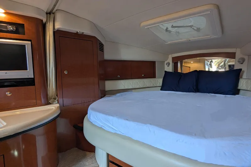  Yacht Photos Pics Luxurious cabin interior of 2004 Sea Ray 340 Sundancer with bed and TV.