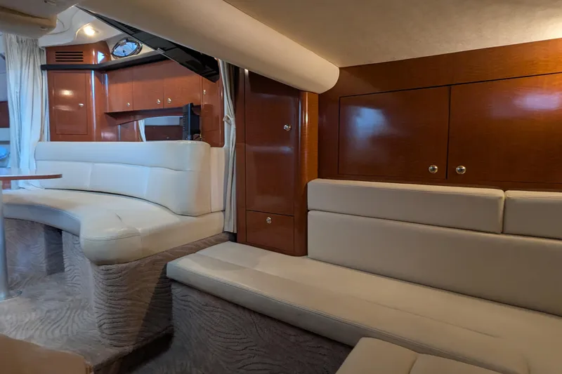  Yacht Photos Pics Luxurious interior of 2004 Sea Ray 340 Sundancer with plush seating and wooden cabinetry.