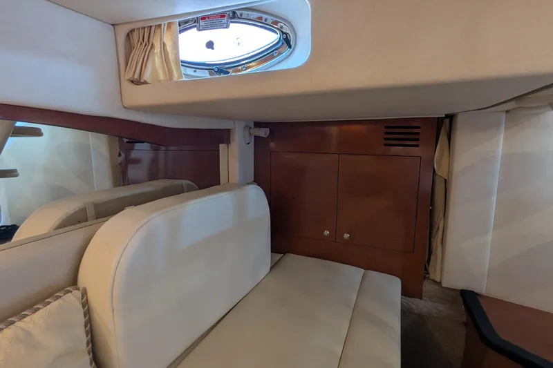  Yacht Photos Pics Interior cabin of 2004 Sea Ray 340 Sundancer with seating and porthole.