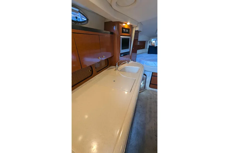  Yacht Photos Pics 2004 Sea Ray 340 Sundancer interior with kitchenette and sleeping area.