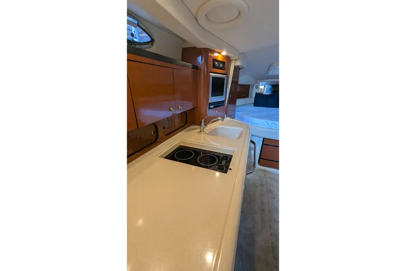  Yacht Photos Pics 2004 Sea Ray 340 Sundancer interior with kitchenette and cozy sleeping area.