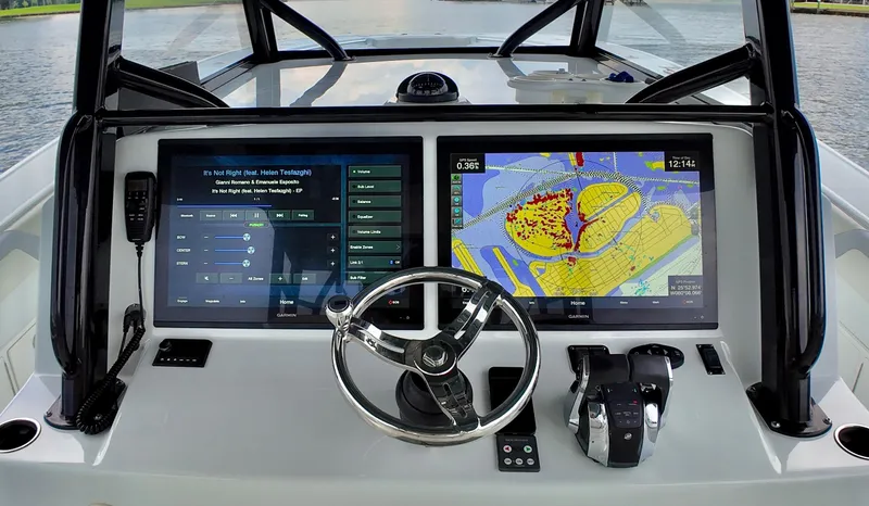  Yacht Photos Pics 2022 Yellowfin 42 Offshore boat dashboard with navigation screens and steering wheel.