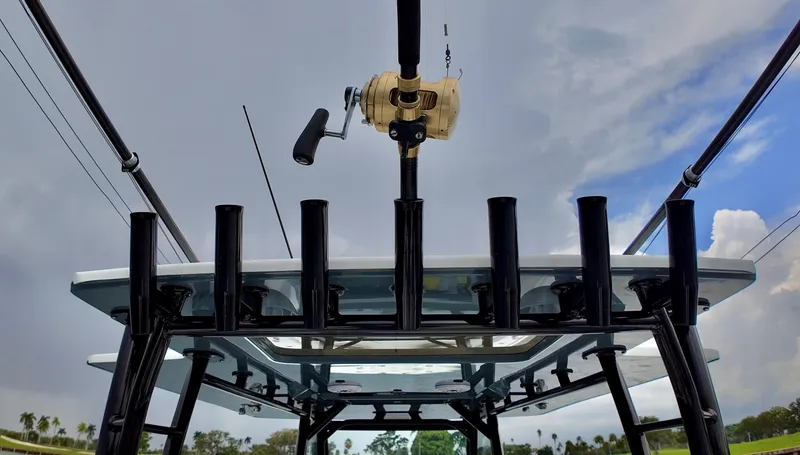  Yacht Photos Pics Fishing rod holder on 2022 Yellowfin 42 Offshore boat against cloudy sky.