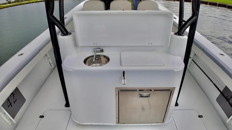  Yacht Photos Pics 2022 Yellowfin 42 Offshore boat interior with sink and storage.