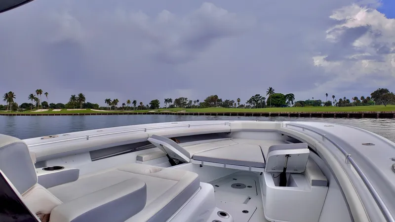 Yacht Photos Pics 2022 Yellowfin 42 Offshore boat on calm water with cloudy sky.