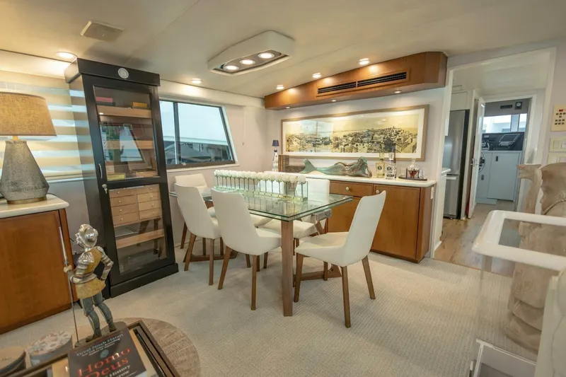  Yacht Photos Pics Luxurious interior of 1989 Hatteras Custom Cockpit yacht with elegant dining area and modern decor.