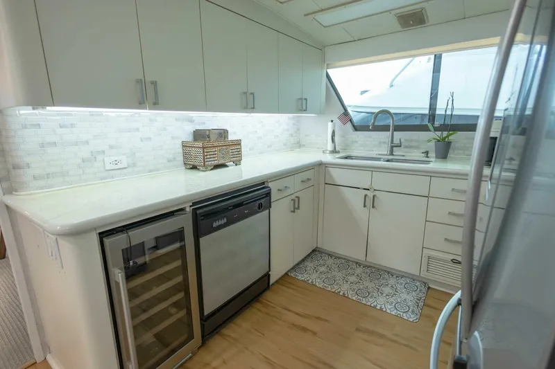  Yacht Photos Pics Modern kitchen in 1989 Hatteras Custom Cockpit yacht with sleek cabinetry and appliances.