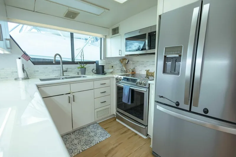  Yacht Photos Pics Modern kitchen in 1989 Hatteras Custom Cockpit yacht with stainless steel appliances.